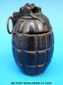 A Mills hand grenade formed into a money box, marked to front with letter F,