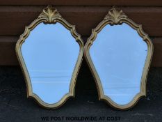 A pair of shaped gilt framed mirrors (height 50cm)