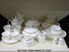 A Royal Doulton six place setting dinner and tea service in Gold Concord pattern