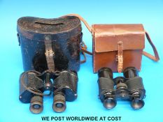 A cased pair of WWII Air Ministry binoculars dated 1944 and marked 6E 293 x 6 together with a