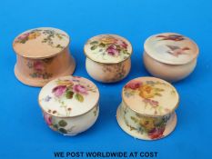 Four Royal Worcester blush ivory circular pill boxes decorated with flowers together with another