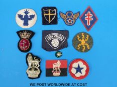A collection of military cloth and cloth backed badges to include Naval,