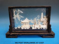 A framed Chinese scene of a house among trees (width 23cm)