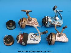Four vintage fixed spool fishing reels including two Ambidex casting reels,