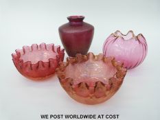 Four pieces of glass including a pair of crimped and ribbed cranberry bowls,