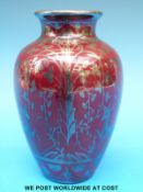A Richard Ginori Art Deco vase decorated with silver lustre deer and foliage against a red ground