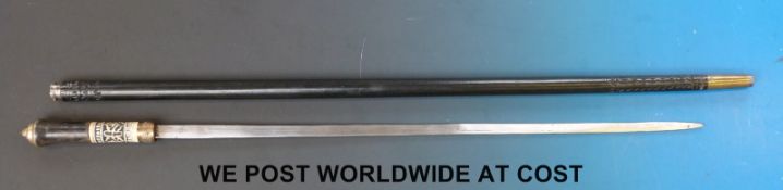 An Eastern sword stick with carved ebony shaft, brass banding,