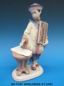 A Lladro figure of Chinese schoolboy with abacus (24cm tall)