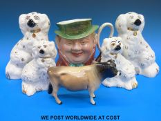 A Beswick cow, two pairs of Staffordshire style dogs, a cow,