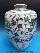 A Chinese blue and white vase of baluster form decorated with sylised flowers (32cm tall)