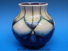 A Moorcroft bulbous pedestal vase decorated in an abstract design 'Indigo' and dated 1999 (16cm