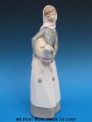 A Lladro figure of a girl holding a lamb (28cm tall)