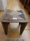 A carved African Zulu milking stool