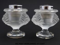 A pair of Lalique glass table lighters of frosted bulbous form on clear pedestal feet decorated