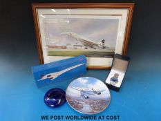A collection of Concorde memorabillia to include a boxed model, a Bristol Blue glass paperweight,