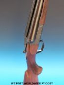 SKB 12 bore double barrelled side by side shotgun with ornate engraving to the locks and chequered