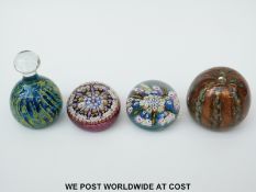 Four glass paperweights,