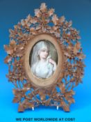 A 19thC oval plaque, possibly KPM / Berlin hand decorated with a portrait of a vestal virgin,
