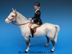 A Beswick huntswoman on grey