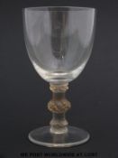 Lalique wine glass raised on triple knopped stem decorated with leaves,