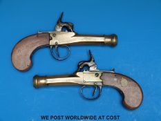A pair of Belgian brass hammer action percussion pocket pistols with stylized dolphin hammers,