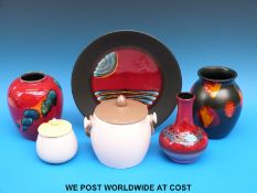 A Poole Pottery hand painted limited edition plate together with three Poole vases,