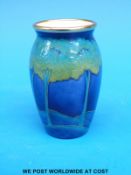 A Moorcroft vase from the enamels range decorated in Moonlit Blue pattern (6cm tall)