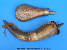 A brass mounted copper flask decorated with embossed scene of dogs flushing birds together with a