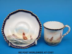 A Royal Worcester demitasse cup and saucer hand decorated with scenes of sailing boats & signed