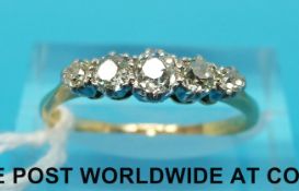A yellow metal ring marked 18ct set with five diamonds in a platinum setting (size P)