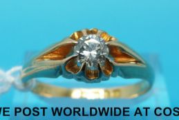 An 18ct gold ring set with a round brilliant cut diamond measuring approximately 0.