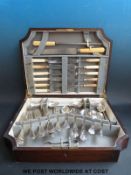 An oak canteen containing assorted cutlery.