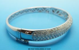 An 18ct white gold bangle,