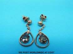A pair of yellow metal earrings marked 18ct set with oval garnets