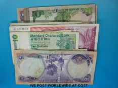 Approximately 52 world banknotes including UK, Oman, Kuwait, Rhodesia,