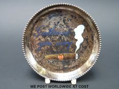 A white metal dish marked 900 to the back and 