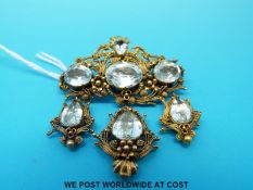 A Georgian filigree brooch of scrolling foliate form set with seven aquamarines,