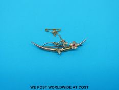 A hallmarked Edwardian 9ct gold brooch set with seed pearls and a ruby