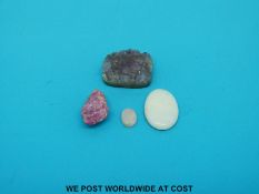 Two oval opal cabochons and a section of amethyst geode