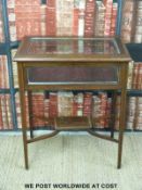 A late 19thC / 20thC silver or bijouterie table with bevelled glass top and four side panels,