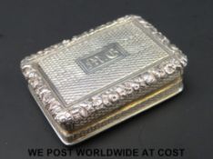 A Georgian hallmarked silver vinagrette with floral edge,