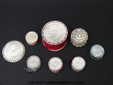 A collection of 19thC carved mother of pearl pin cushions, largest 2cm tall,