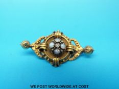 A yellow metal brooch set with opals and a diamond