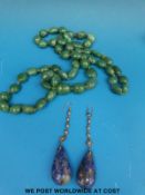 A pair of earrings set with diamonds with drop lapis sections and an aventurine beaded necklace