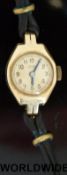 A Swiss made 18ct gold ladies wristwatch with engraved detail to the case of roses and foliage and