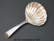 A Georgian hallmarked silver caddy spoon with scallop shaped bowl and bright cut handle,