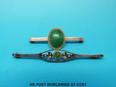 A 9ct gold brooch set with malachite and a 9ct gold bar brooch set with peridot and seed pearl
