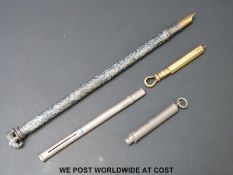 An Indian white metal pen with elephant finial,
