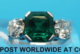An 18ct white gold ring set with an Asscher cut emerald of approximately 2.