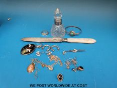 A silver bladed, mother of pearl handled knife and a silver rimmed cut glass scent bottle,